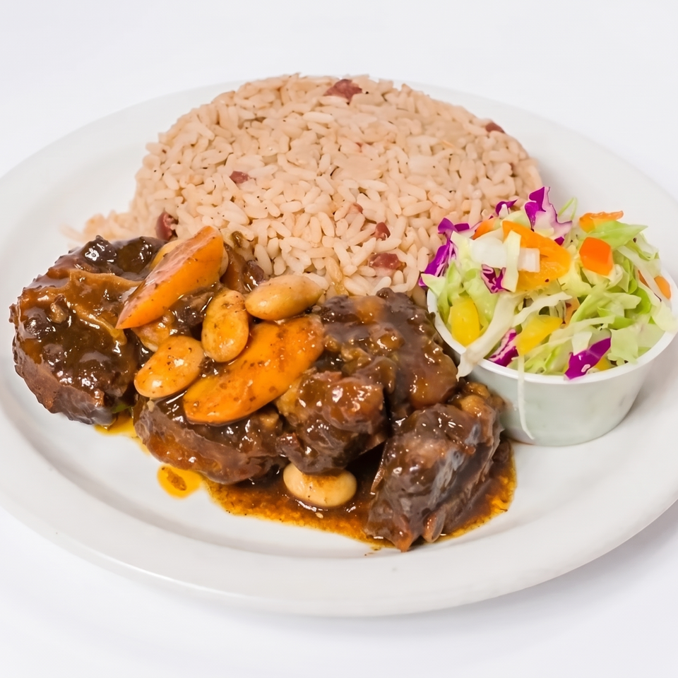 Plate of saucy braised beef with carrots and beans, seasoned rice, and a colorful side salad.